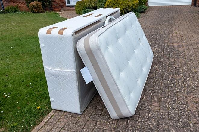 throwing away old mattress at the dump